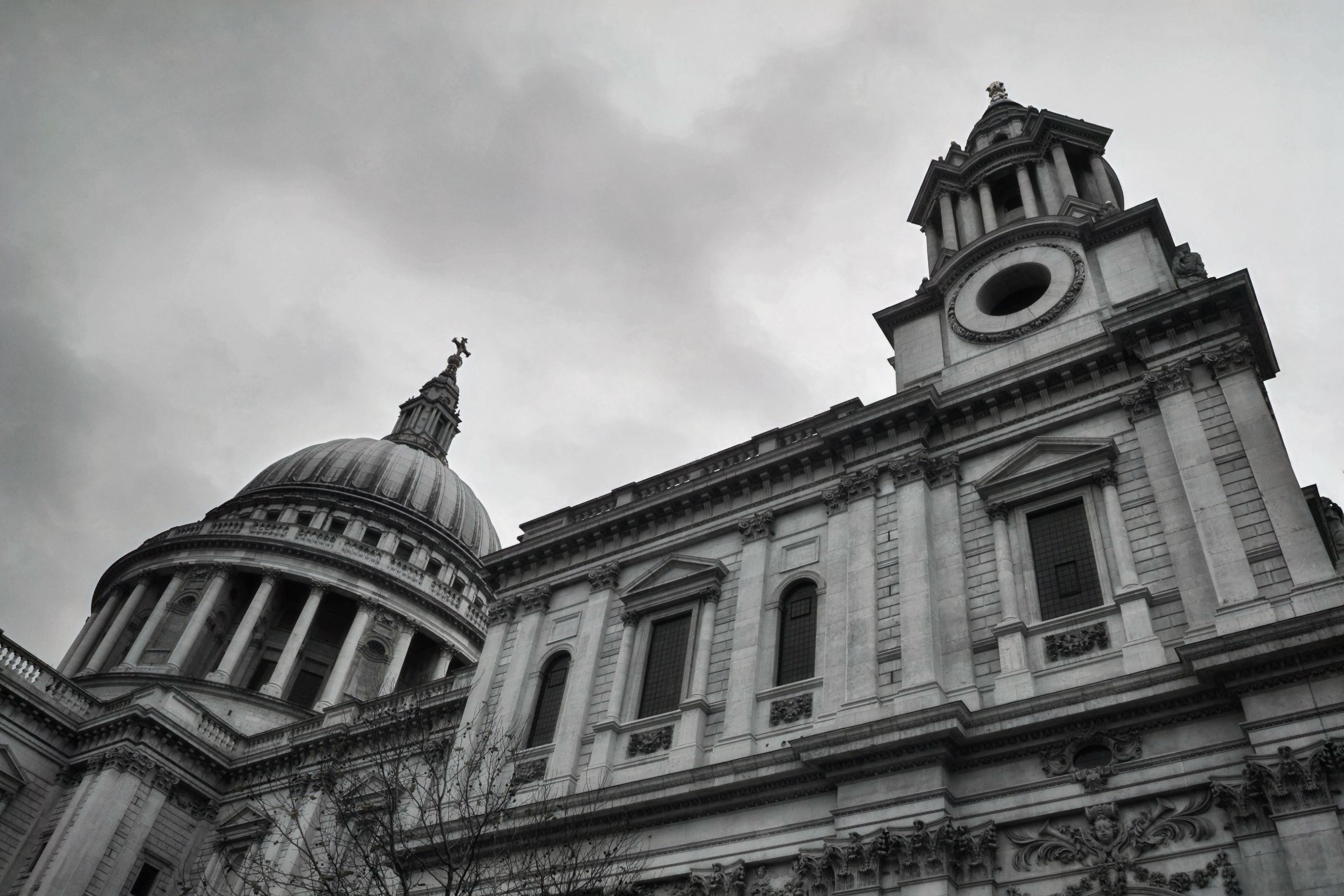 A dramatic view of St Paul's Cathedral in London, emphasizing its classic architecture against a moody sky.