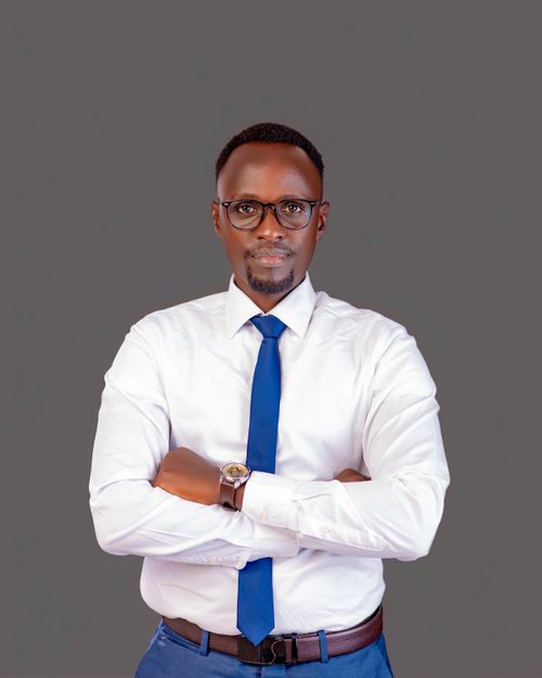 Free Portrait of a confident businessman in a white shirt and blue tie, standing against a neutral background. Stock Photo
