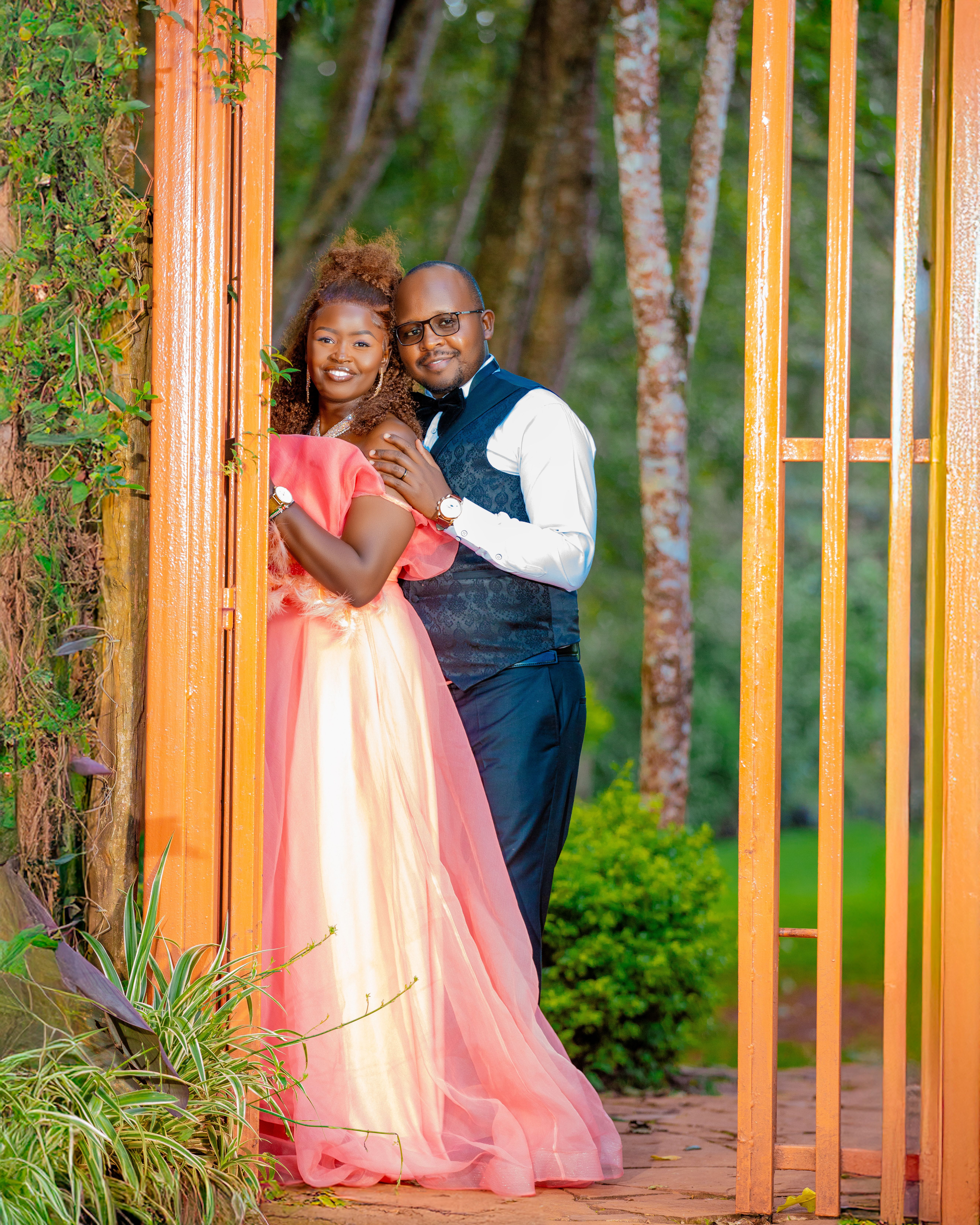 Elegant couple posing in a lush garden wedding photo, showcasing love and joy.