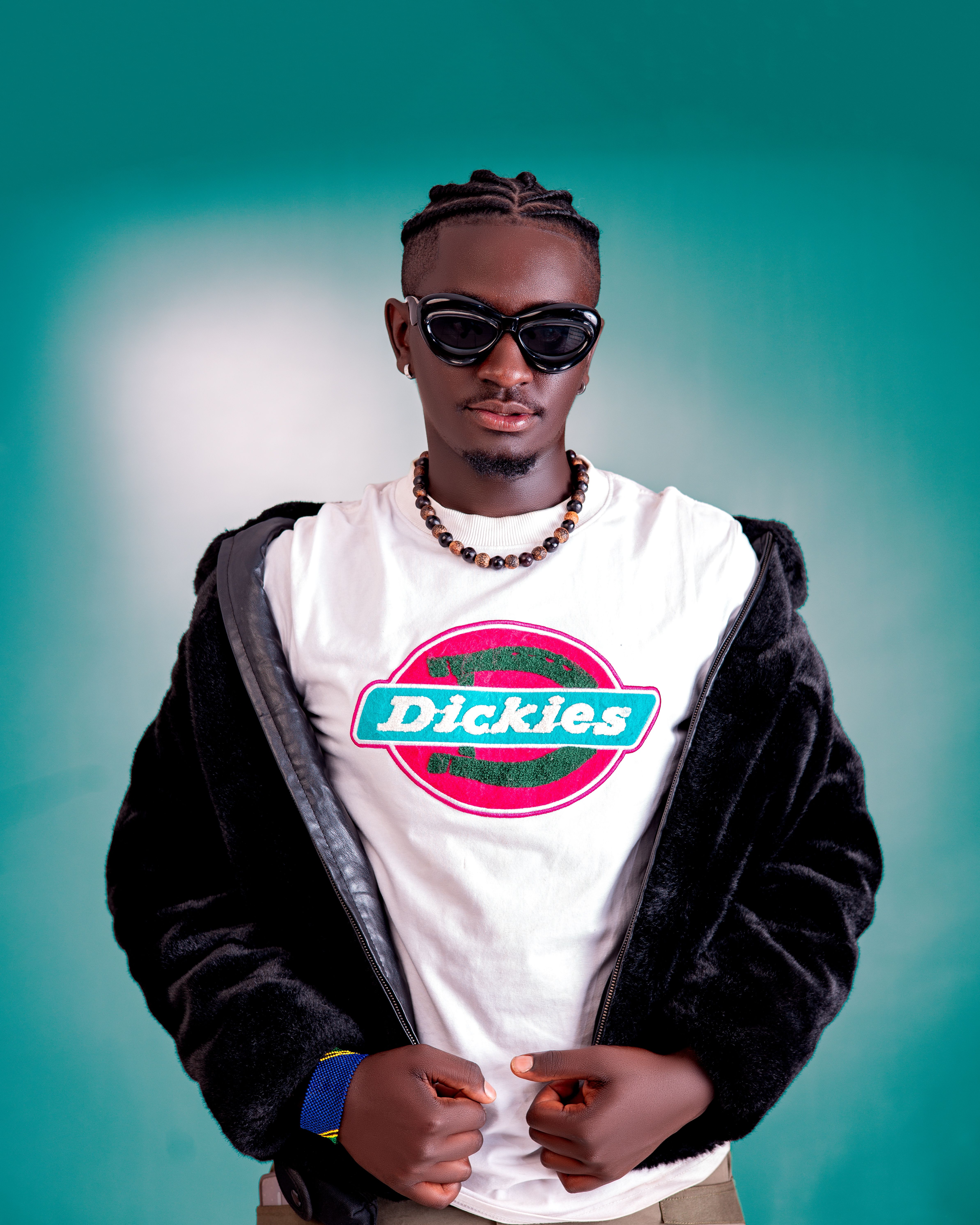 Confident adult male wearing sunglasses and branded outfit, exuding modern fashion style.