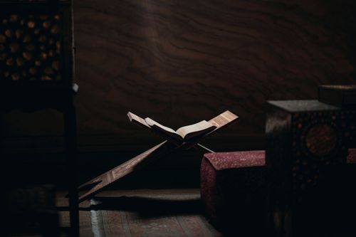 Free Dimly lit corner of Hagia Sophia showing a Quran on a wooden stand highlighting spiritual tranquility. Stock Photo