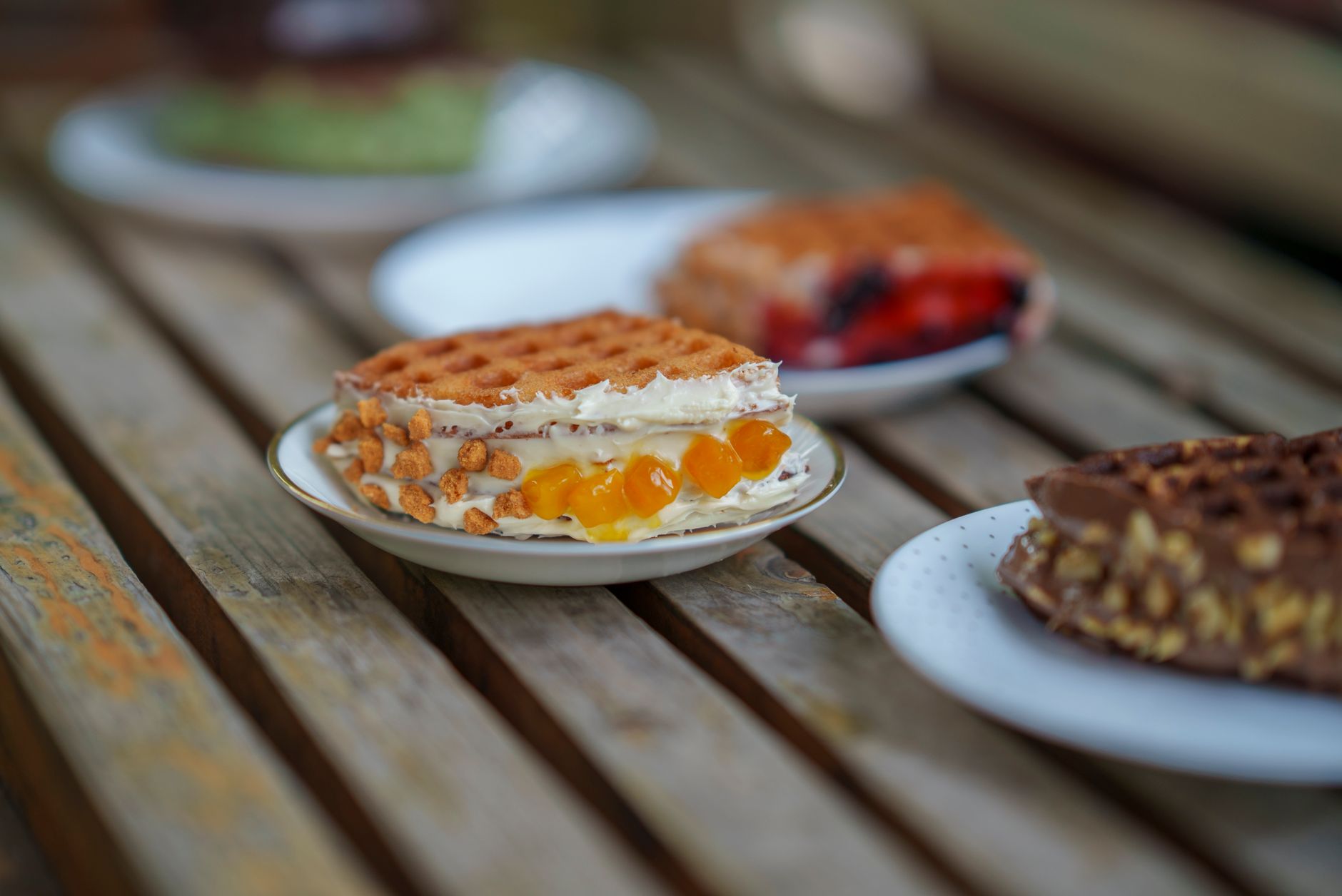 Healthy breakfast spread with cottage cheese waffles, nuts, and berries