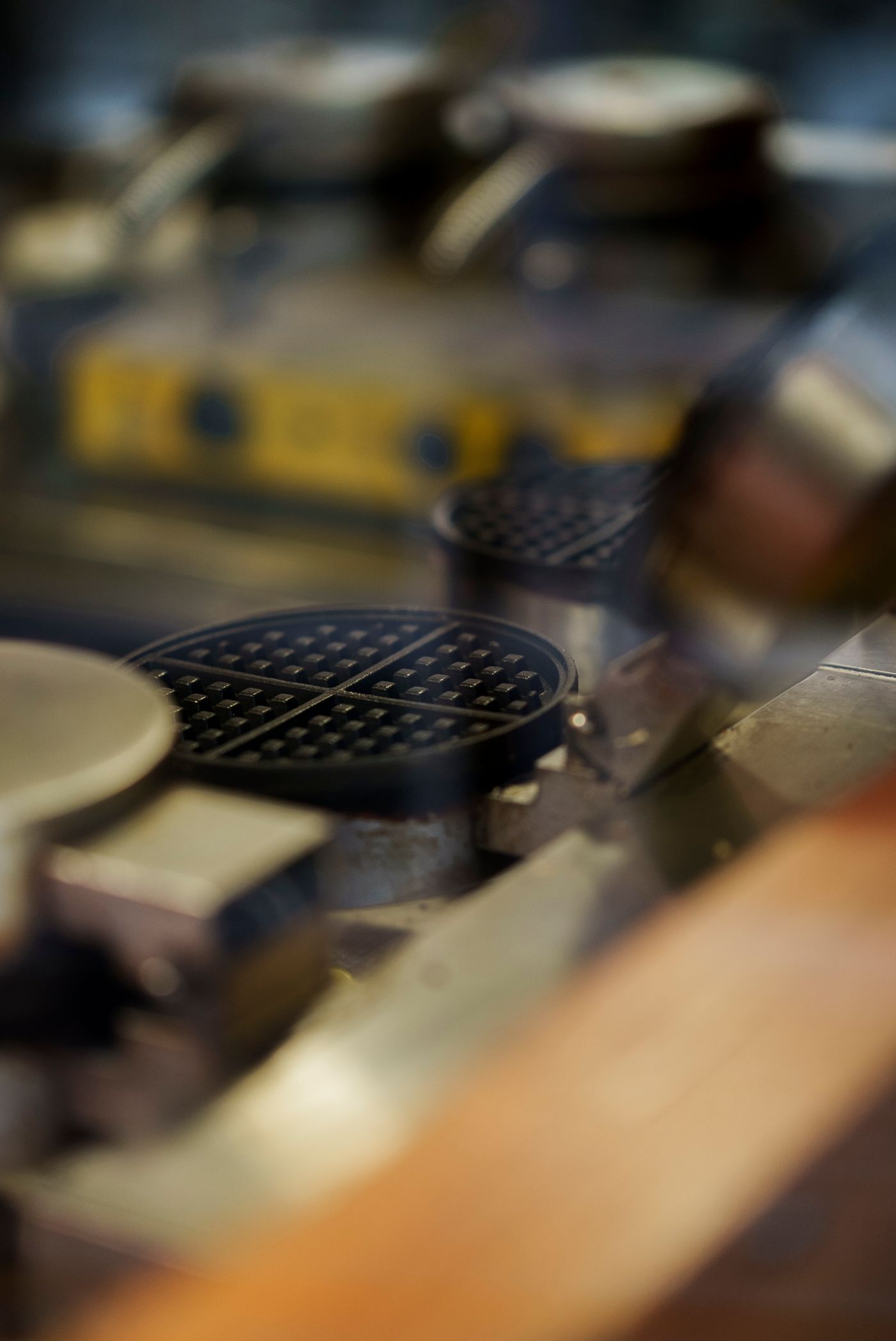 Hot waffle maker in use during waffle cooking