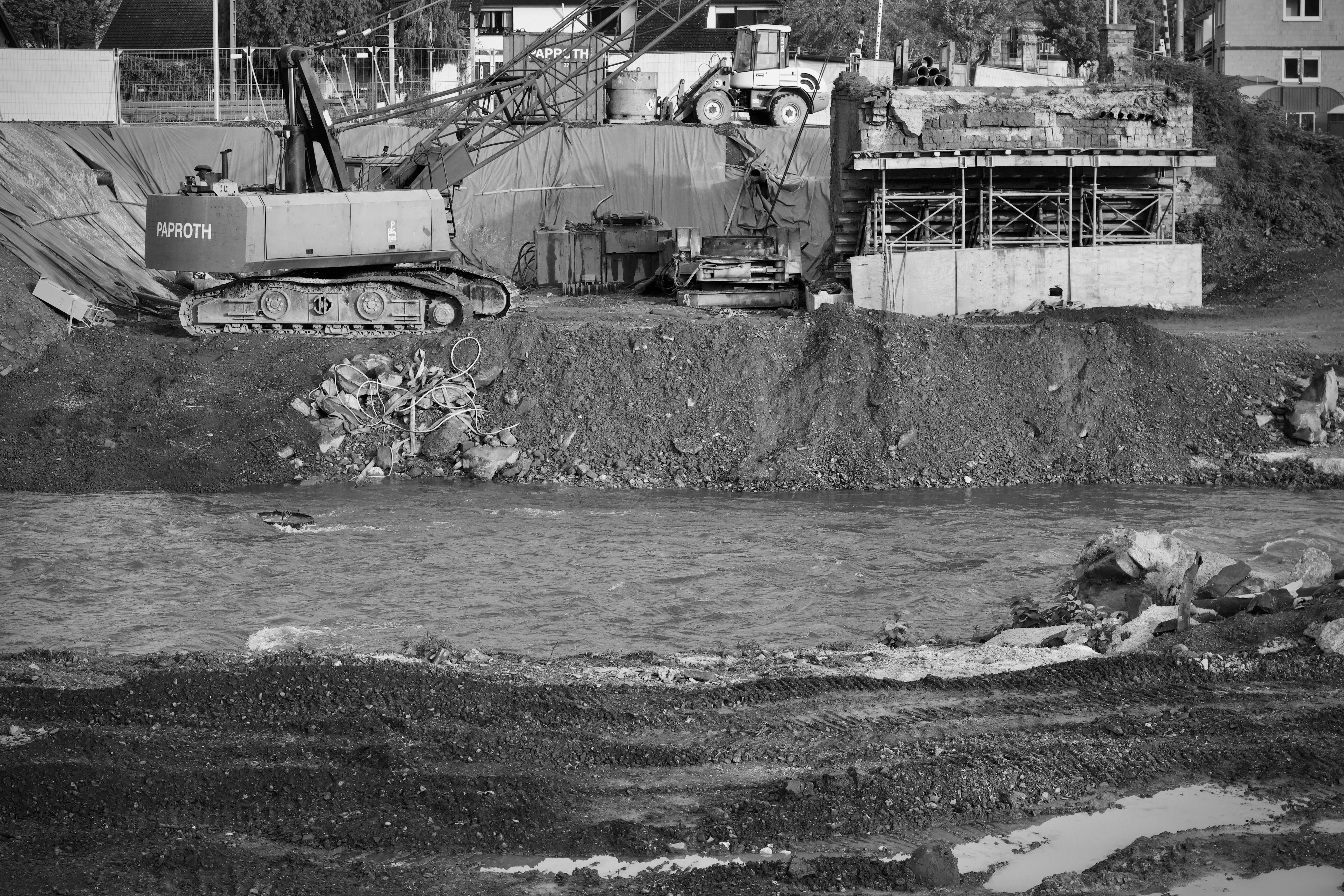 Monochrome construction site featuring an excavator