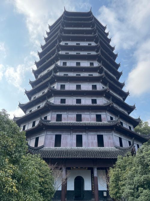 Free A tall, traditional Chinese pagoda set against a bright blue sky in Hangzhou, China. Stock Photo