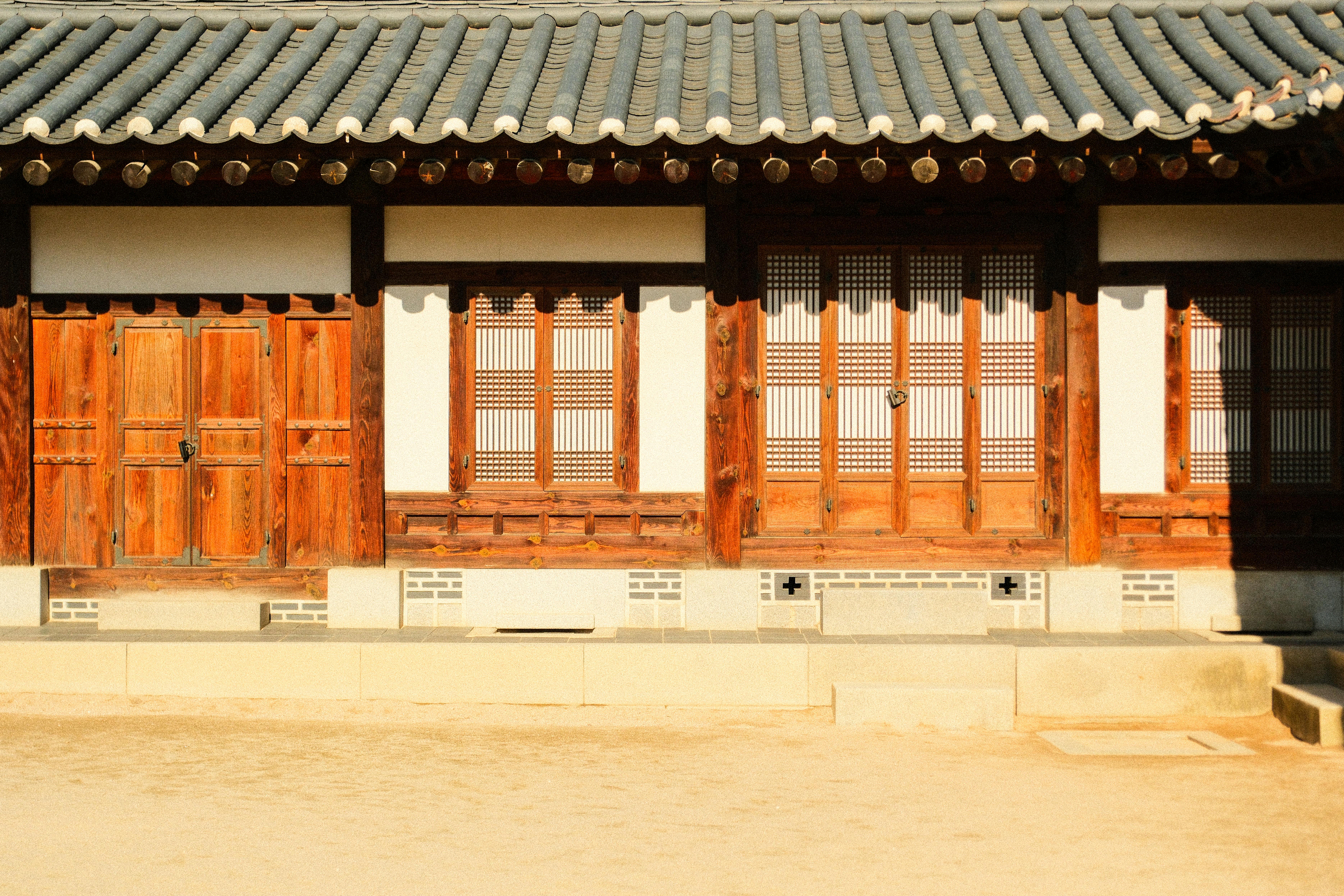 Renovated Korean house interior with low wooden beams and Japanese-Italian plates
