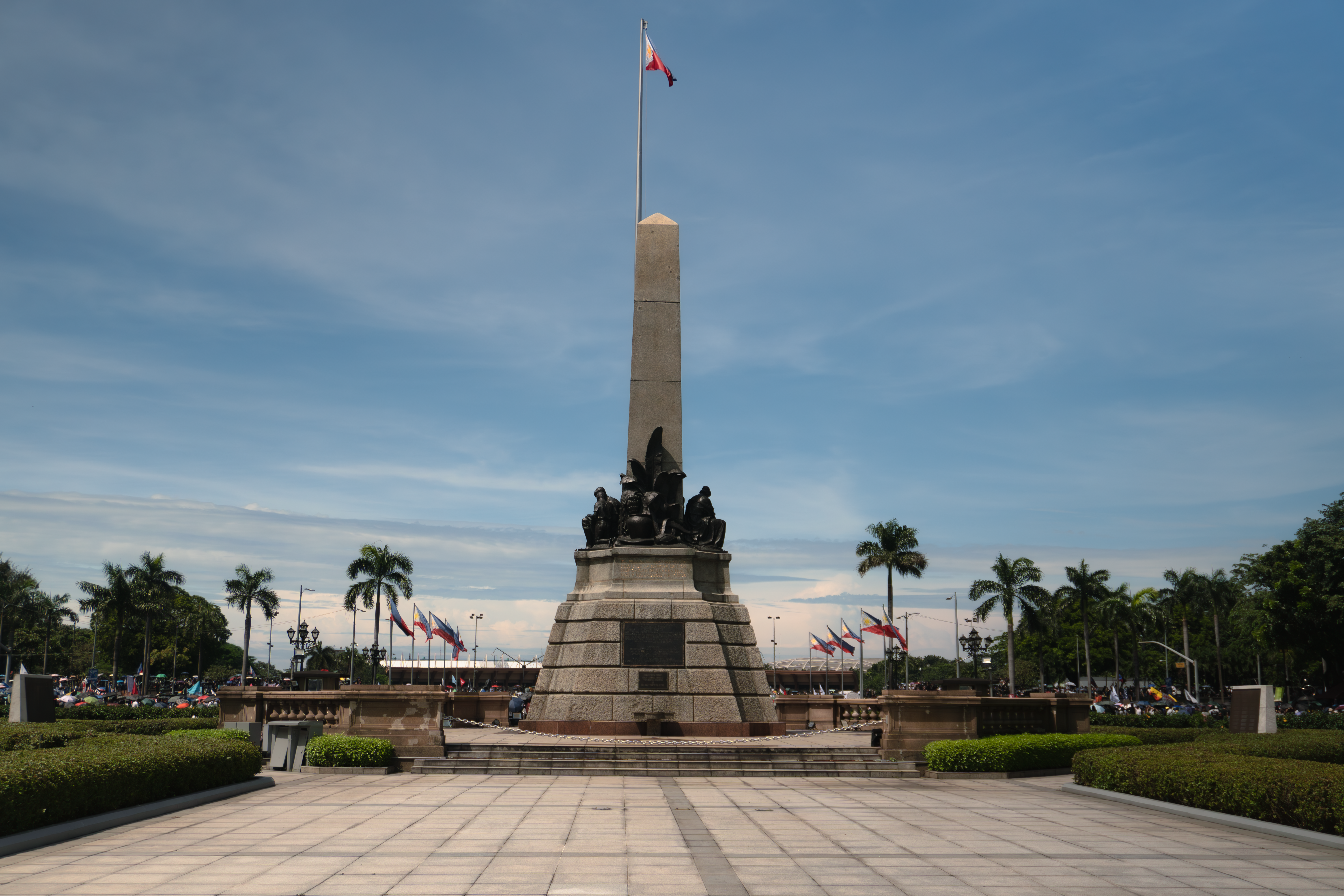 The iconic Rizal Monument in Rizal Park, Manila, under a clear sky.