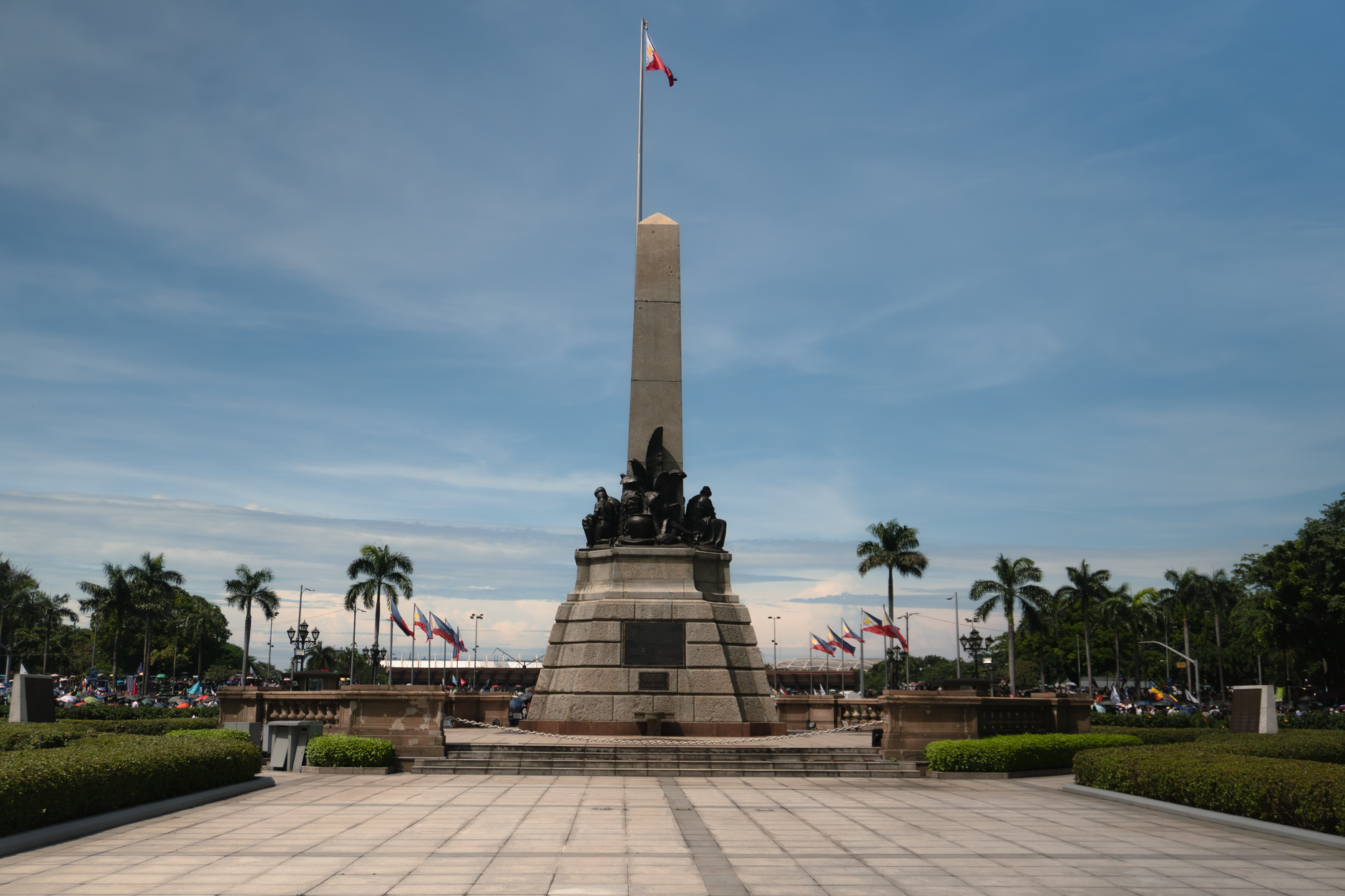 The iconic Rizal Monument in Rizal Park, Manila, under a clear sky.