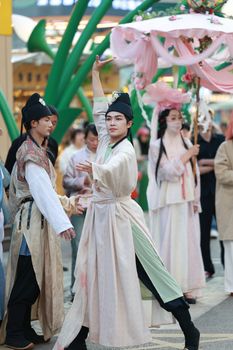 Vibrant traditional dance with performers in elegant, historical costumes. Captivating cultural display.