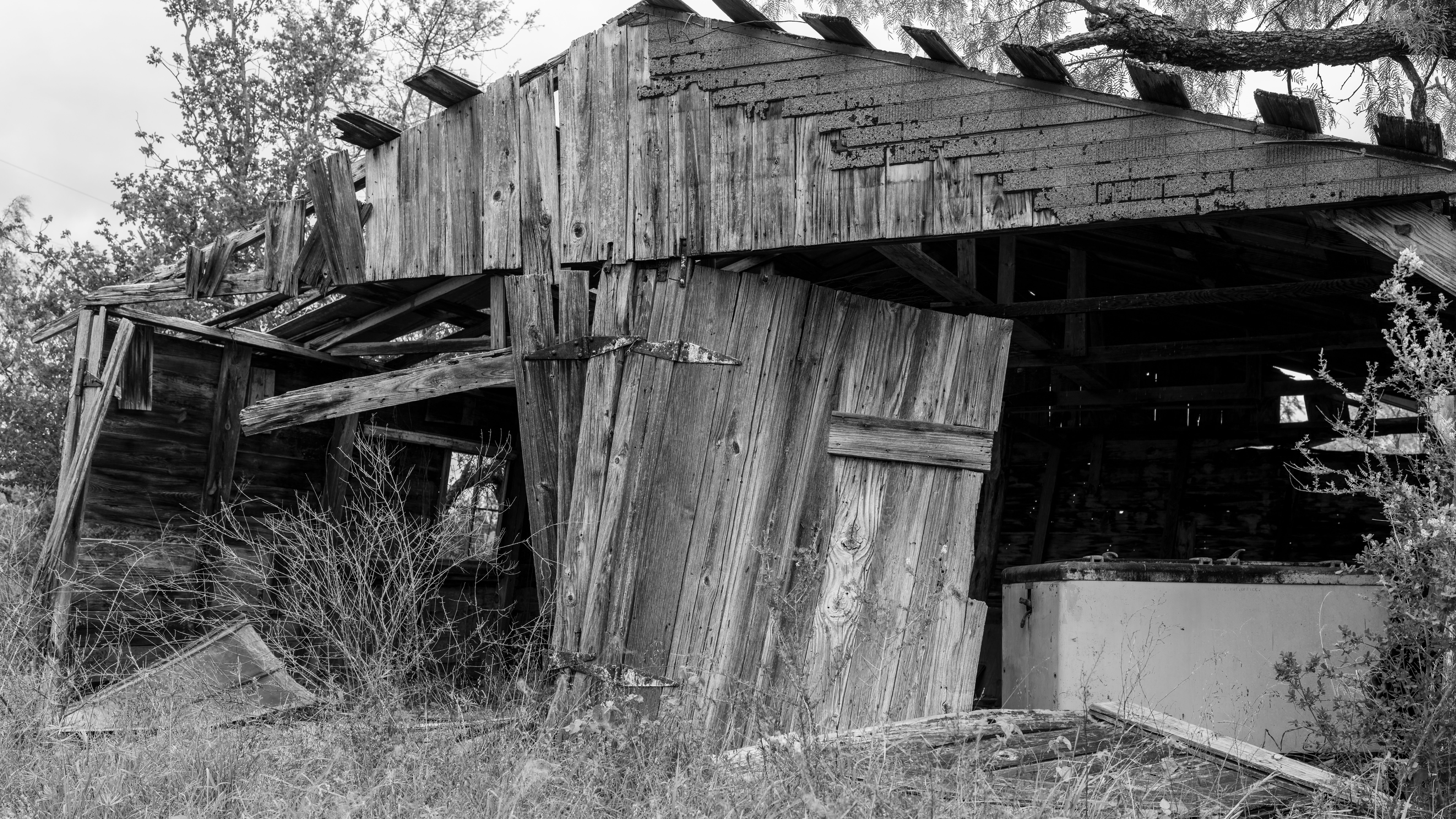 Explore the rustic charm of a weathered barn in Texas, captured in monochrome. Perfect for themes of abandonment and rustic scenery.