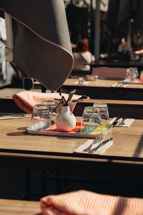 Free A bright outdoor café setup with glasses and napkins in Berlin, capturing urban leisure and springtime vibes. Stock Photo