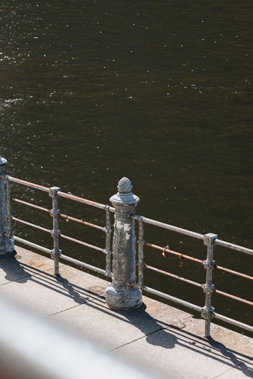 Free View of an old metal railing along the Spree River in Berlin, Germany. Stock Photo