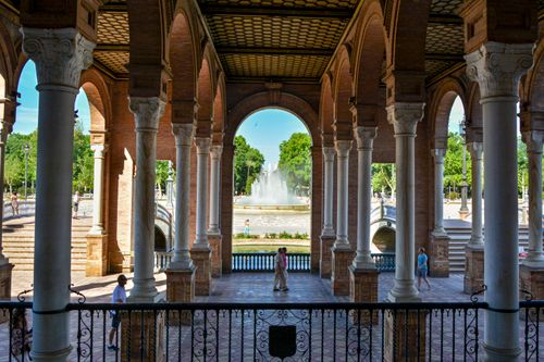 Free Inside view of Plaza de España in Sevilla featuring elegant arches and a central fountain, captured in daylight. Stock Photo