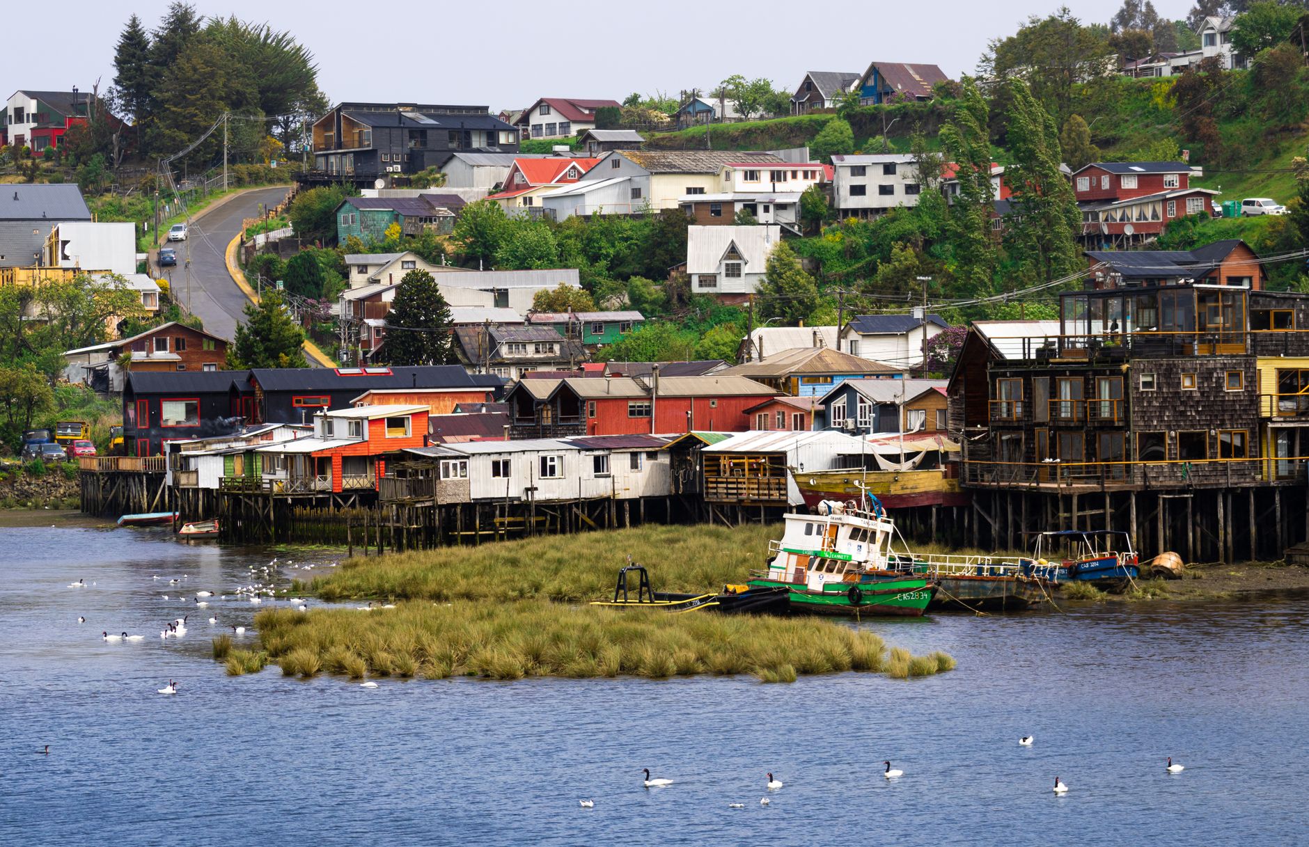 Charming stilt houses and boats on the shoreline of Castro, Chiloé Island, Chile.