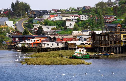 Free Charming stilt houses and boats on the shoreline of Castro, Chiloé Island, Chile. Stock Photo