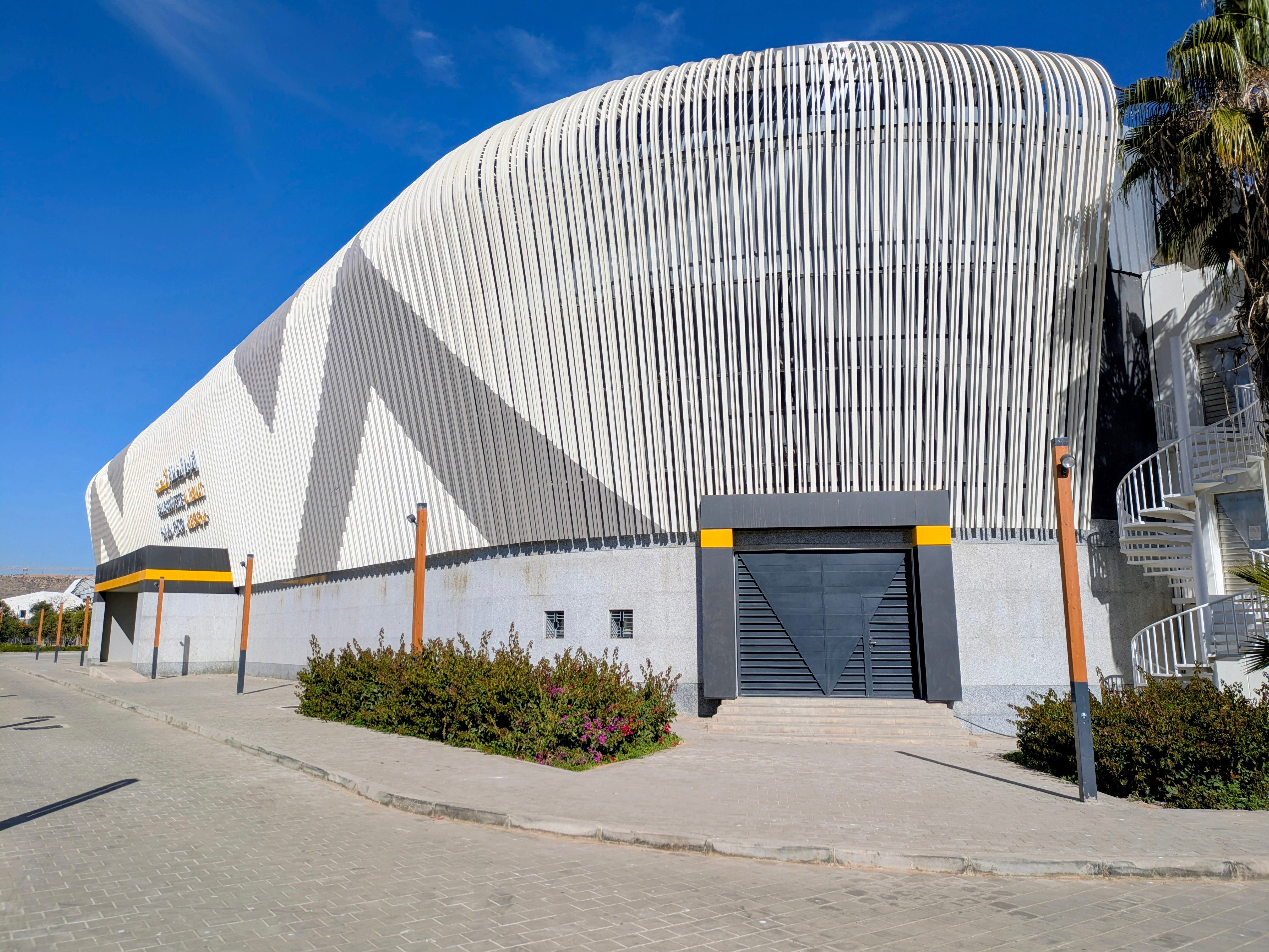 Contemporary building featuring a distinctive facade design with vertical elements under a clear sky.