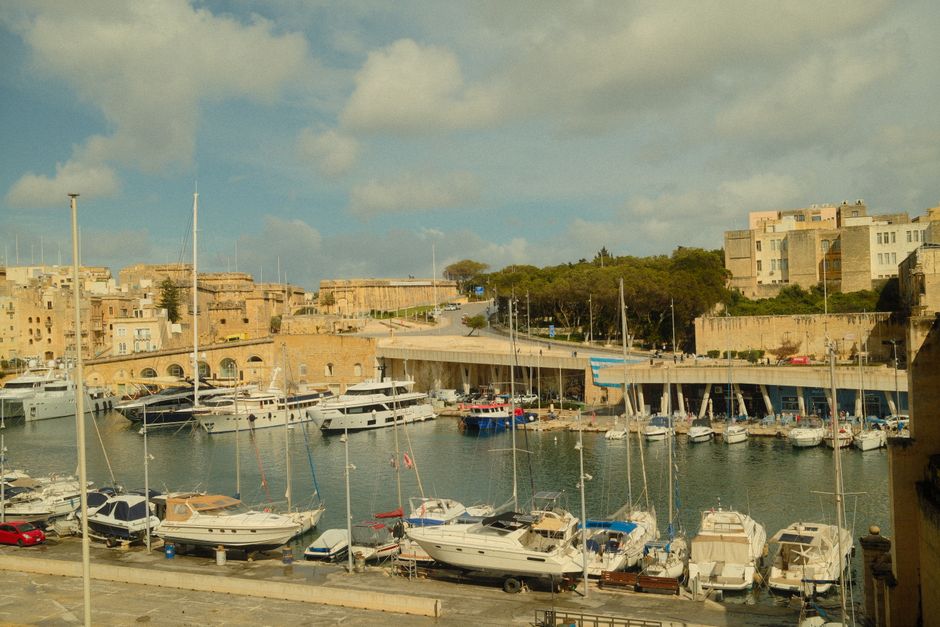 Incredible Private Day Trip on Modern Catamaran Malta Gozo and Comino Review: The Ultimate Maltese Islands Experience Review 2026 - A scenic harbor with yachts and historic structures under a bright blue sky, capturing a sense of travel and adventure.