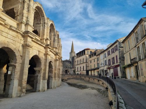 Free View of the Roman Amphitheater and charming street scene in Arles, Provence, France. Stock Photo