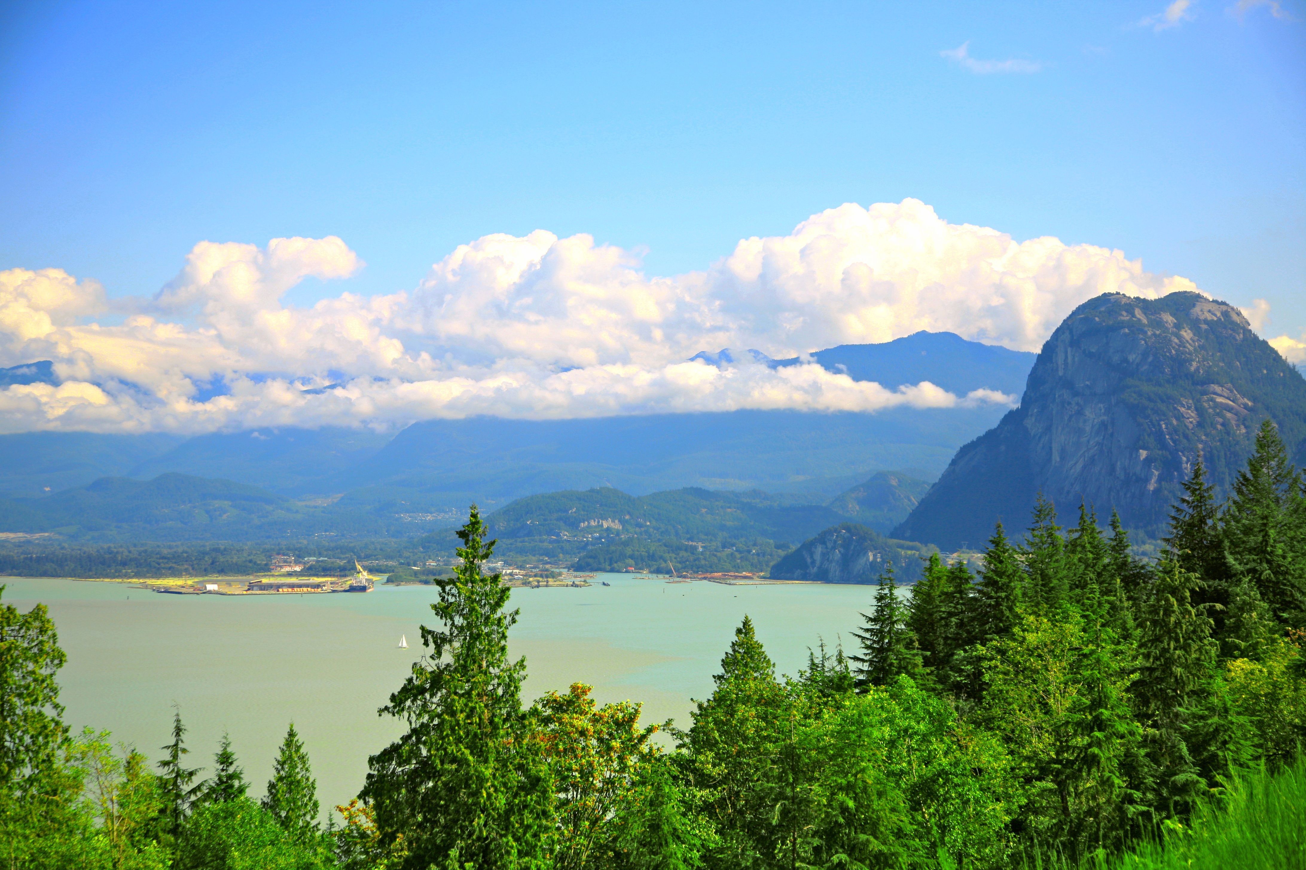A breathtaking view of Howe Sound with coastal mountains under a bright summer sky.