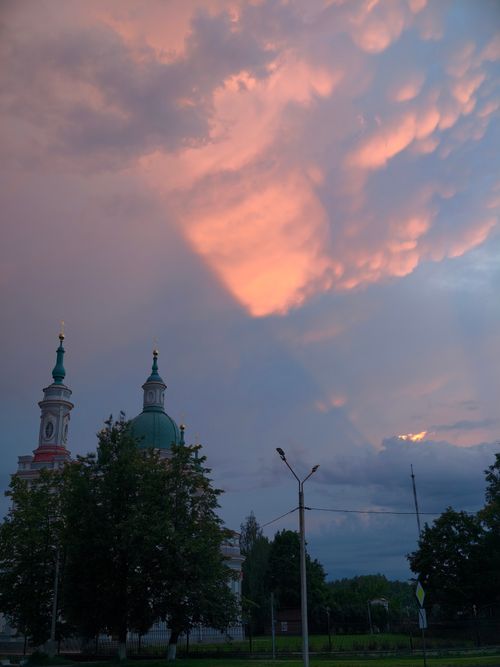 Free Beautiful evening view of a historic church skyline with dramatic clouds. Stock Photo