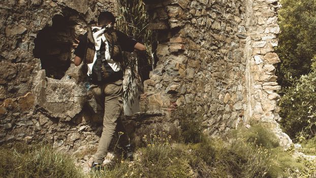 Man explores ancient stone ruins in El-Hamdania, Algeria.