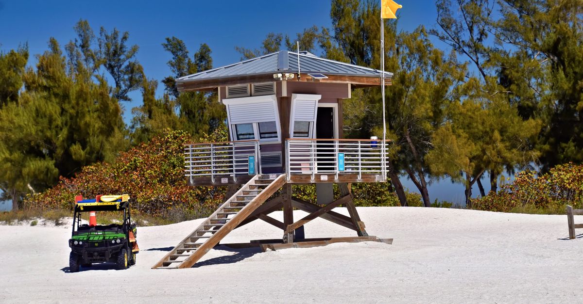 A lifeguard station on a sunny day at Bradenton Beach, Florida, with trees in the background.