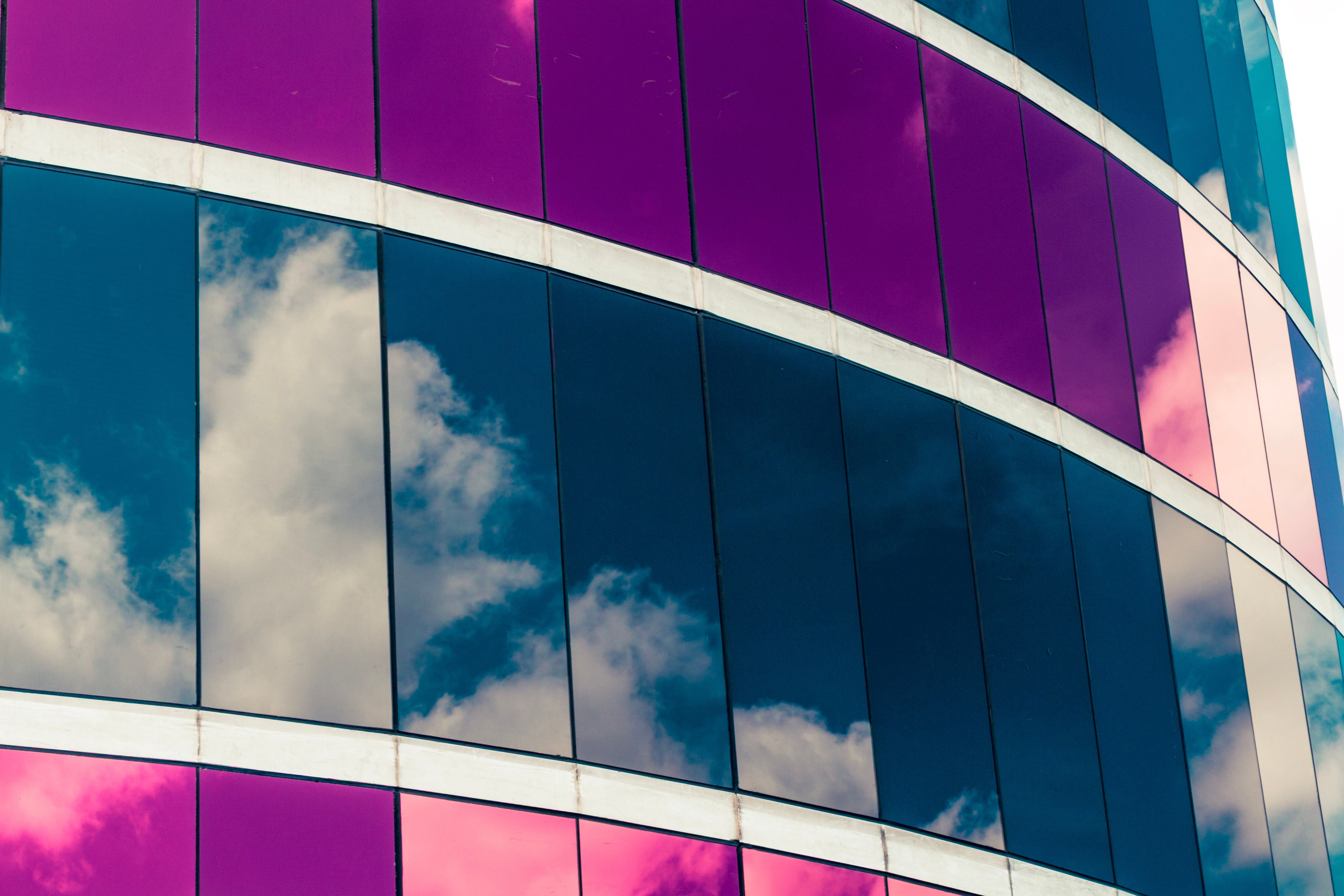 Vibrant reflections of the sky on the mirrored glass facade of a modern building.
