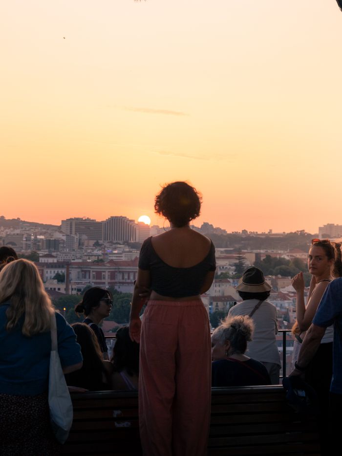 A group watching the sunset over Lisbon