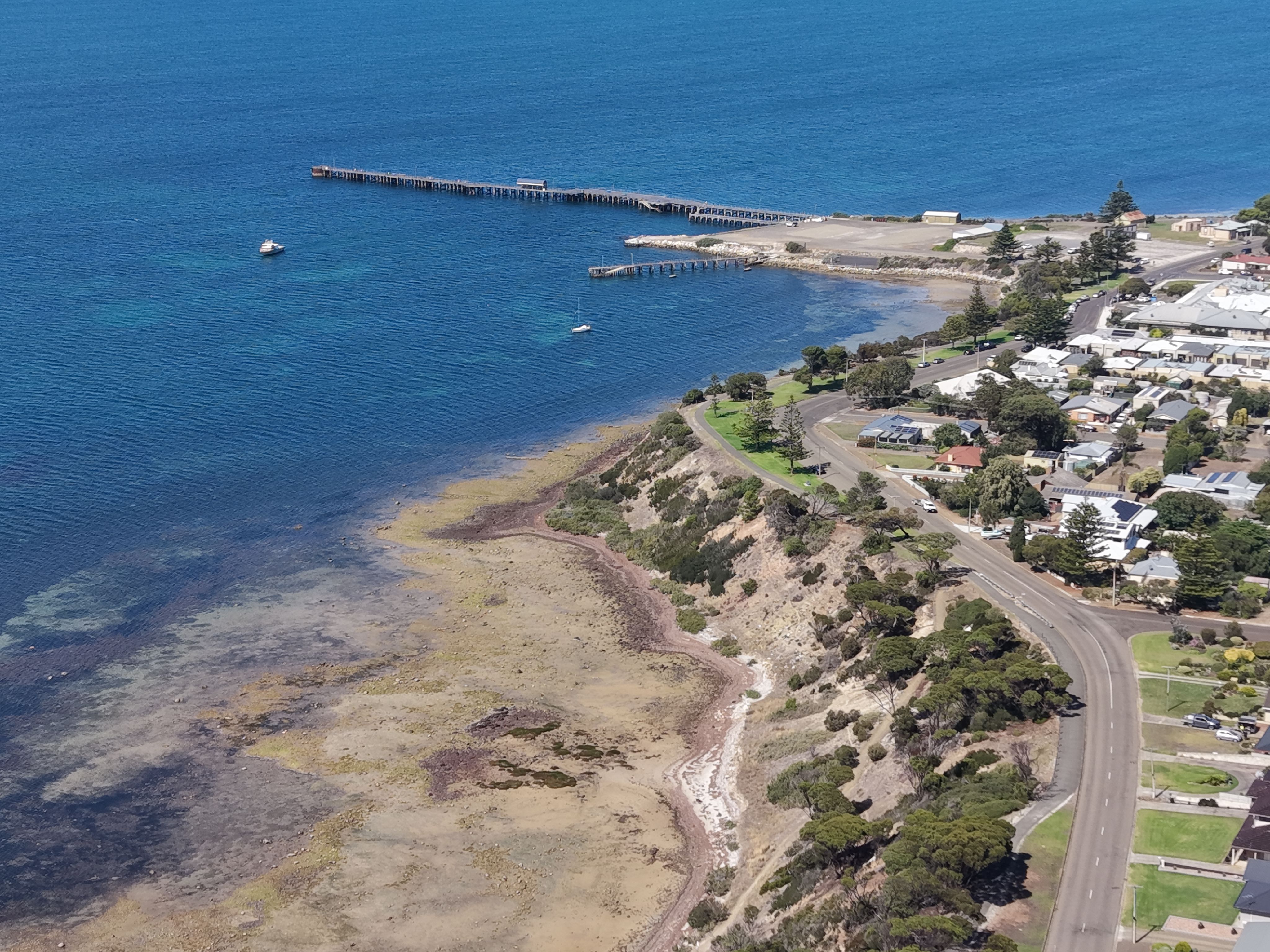 Stunning aerial shot of Penneshaw coastline featuring clear blue waters and rocky shores.