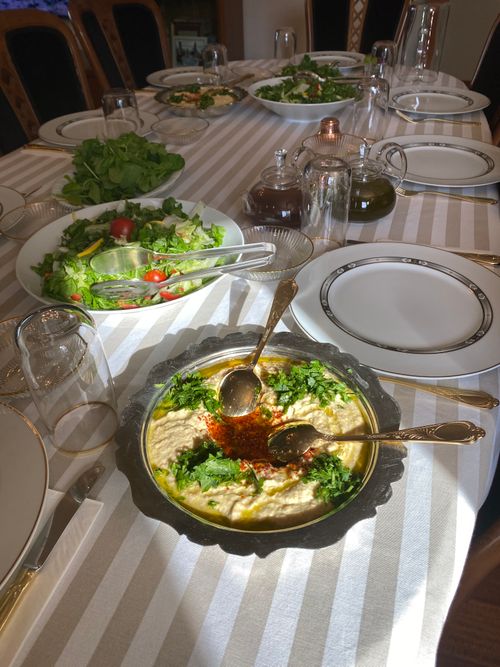 Free A beautifully set Turkish dining table featuring hummus and fresh salads, ready for guests. Stock Photo