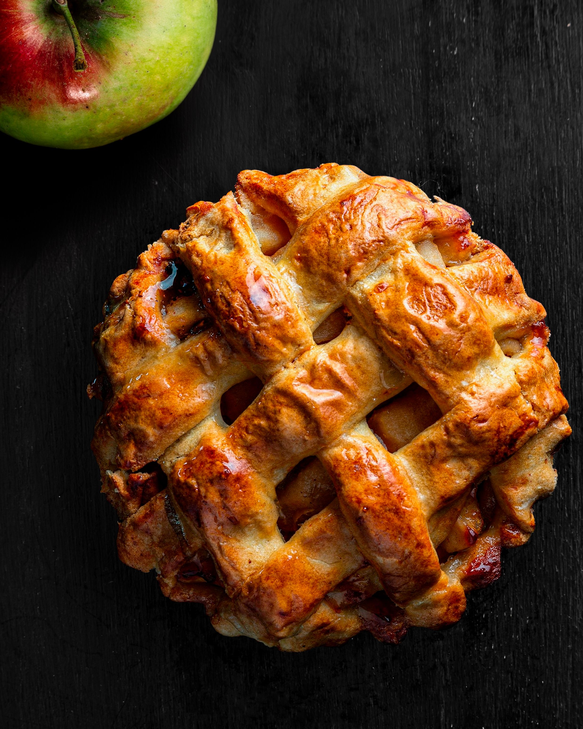 Finished classic apple pie with a lattice crust, flavoured with cinnamon & vanilla