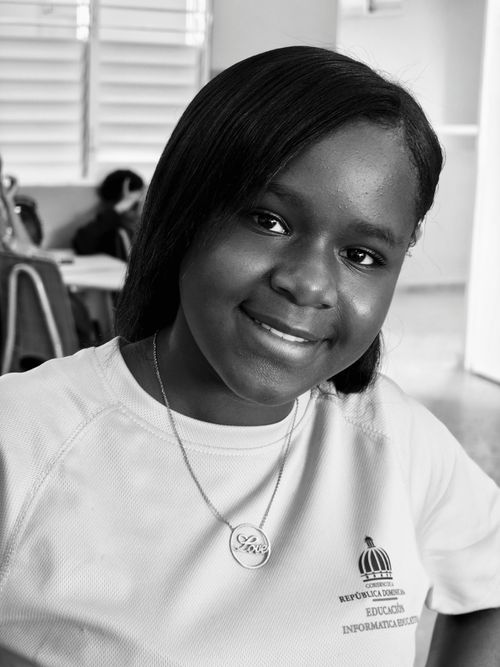 Free Black and white portrait of a smiling student in a classroom setting. Stock Photo