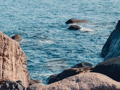 Peaceful coastal scene with rocks and blue sea waves at Ninh Thuan, Vietnam.