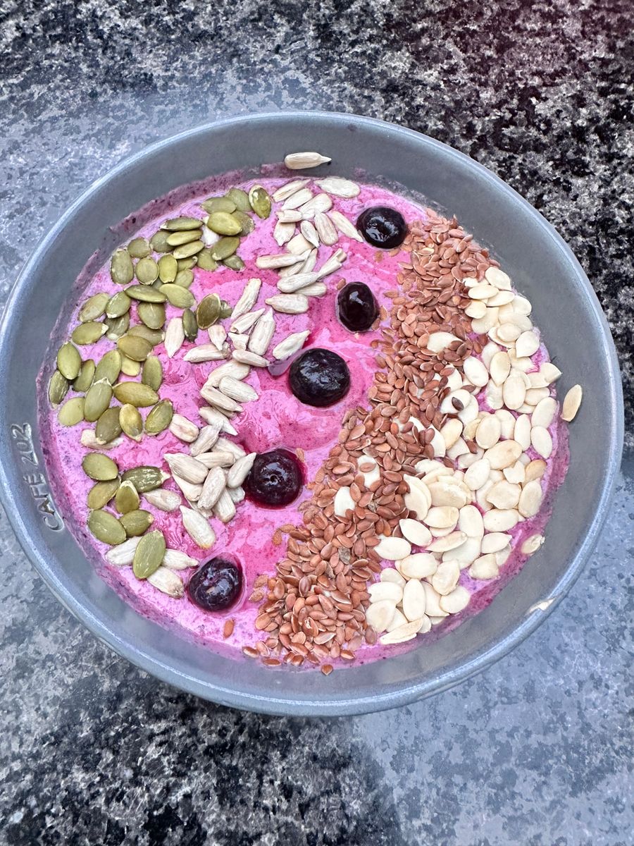 Colorful smoothie bowl with seeds and cherries
