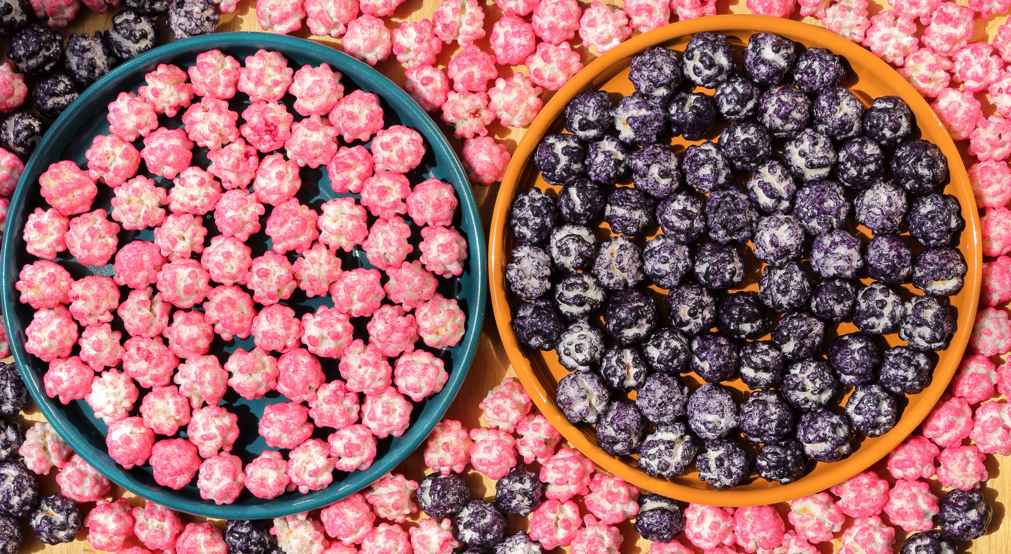 Vibrant Popcorn Display in Orange and Blue Bowls · Free Stock Photo