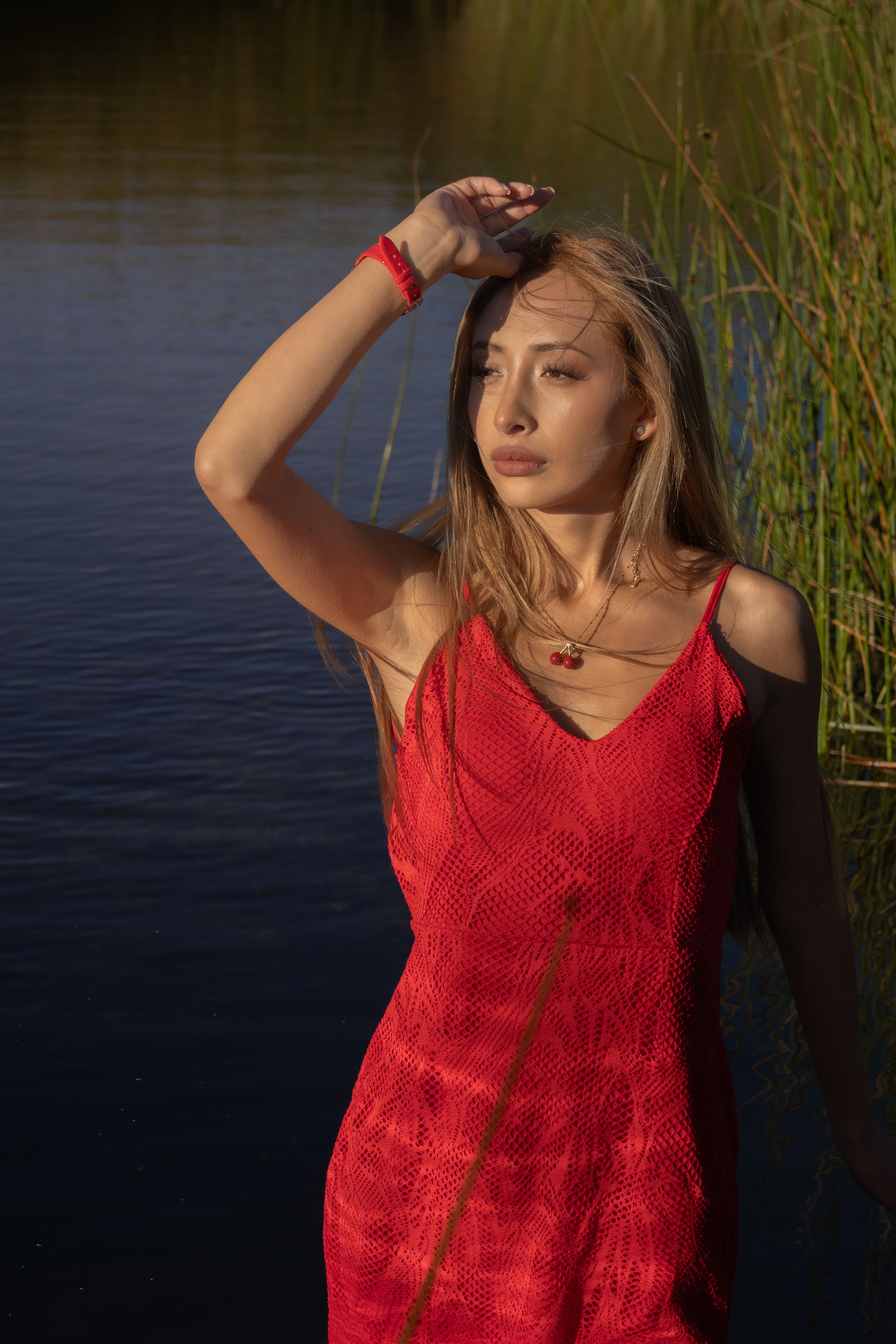 Woman in Red Dress by the Water at Sunset · Free Stock Photo
