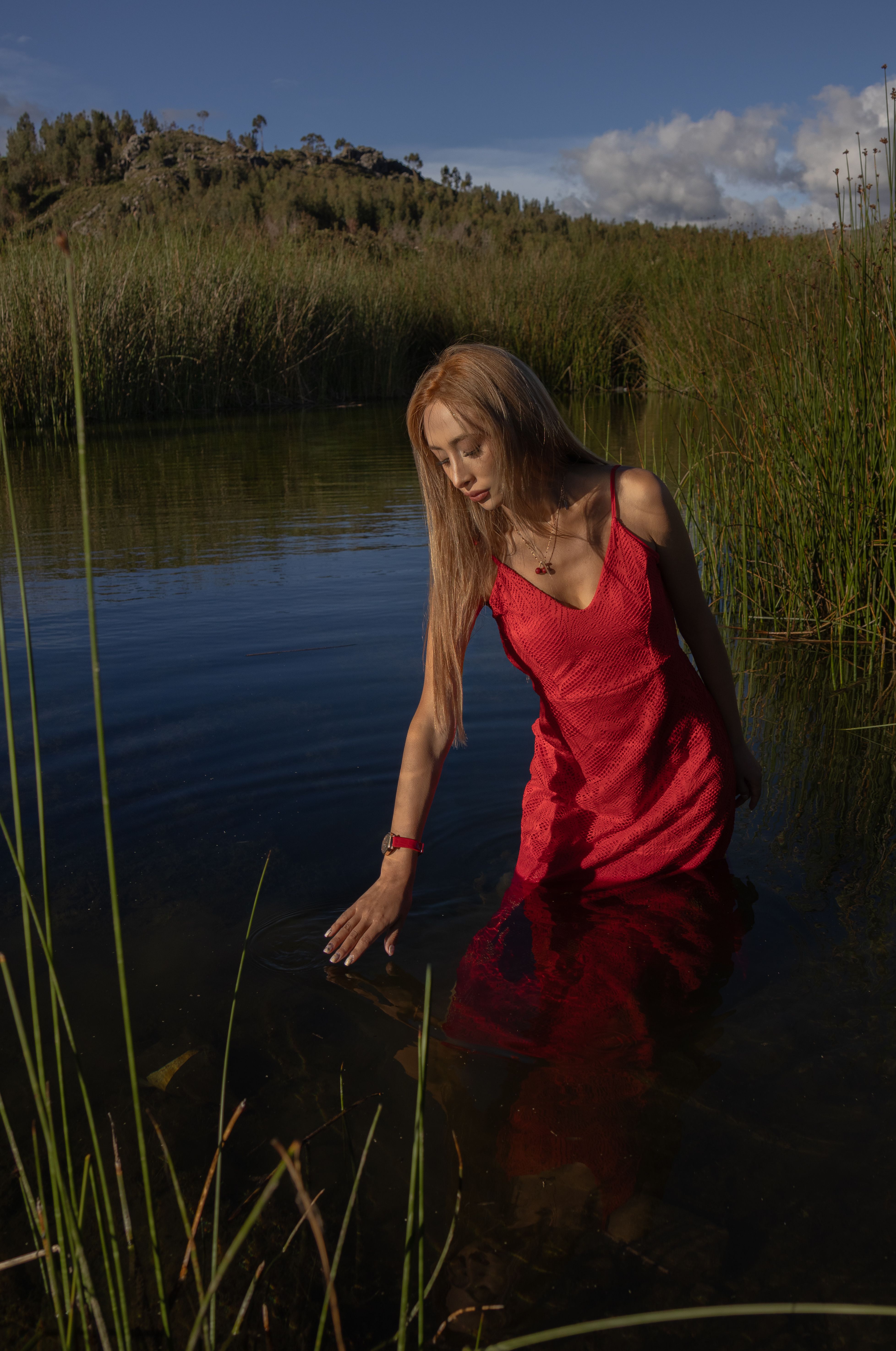 Woman in a Red Dress Standing in a Lake · Free Stock Photo