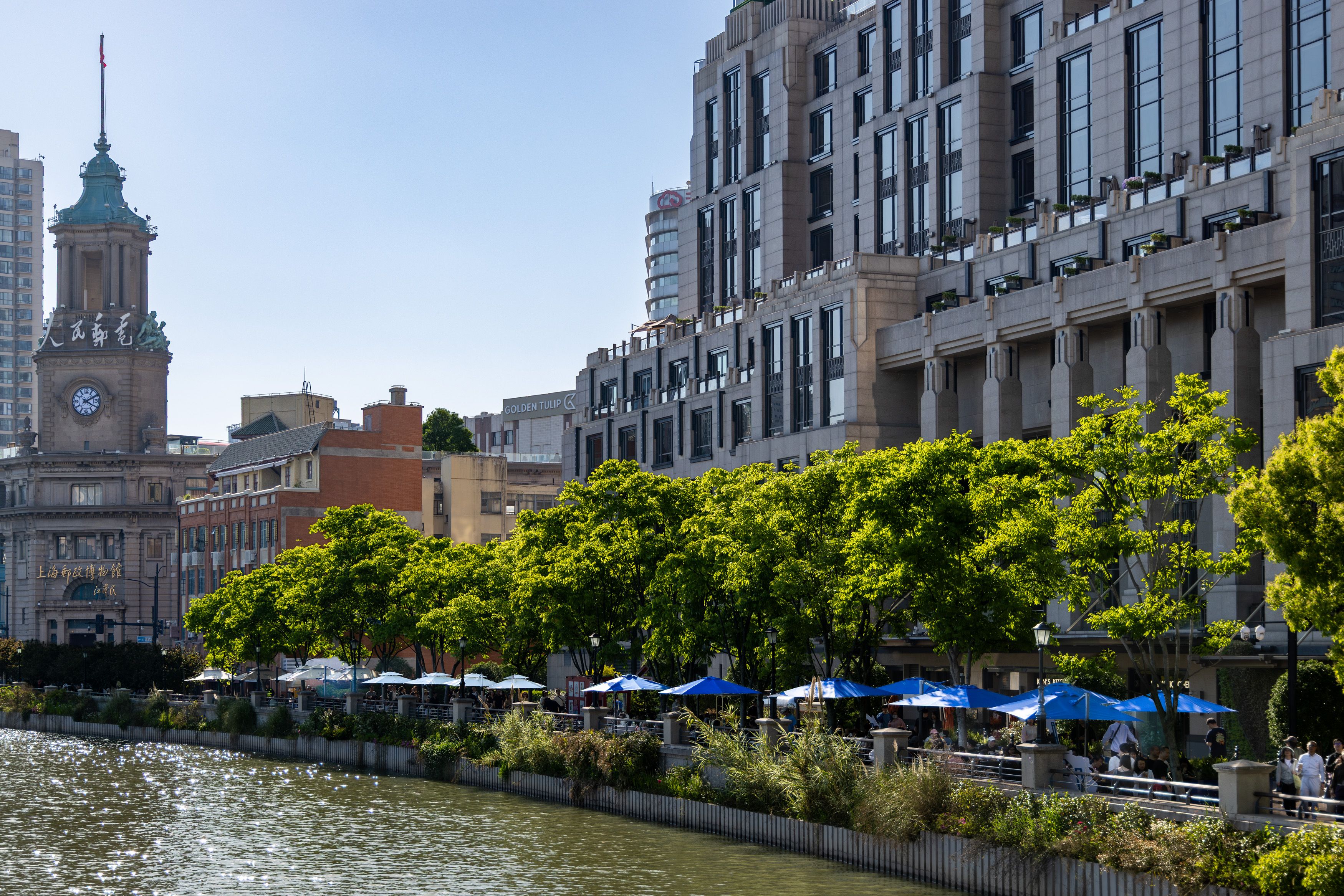 Historic Clock Tower by Riverside Promenade · Free Stock Photo