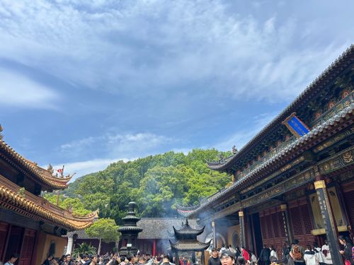 Free A bustling scene at a traditional Chinese temple with worshippers and architectural beauty under a clear blue sky. Stock Photo