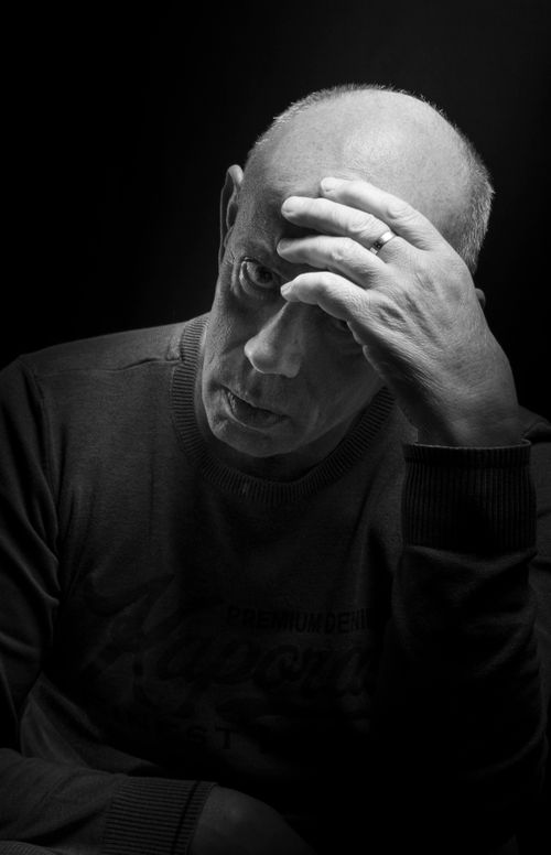 Free Black and white portrait of a senior man in deep thought, highlighting emotions. Stock Photo