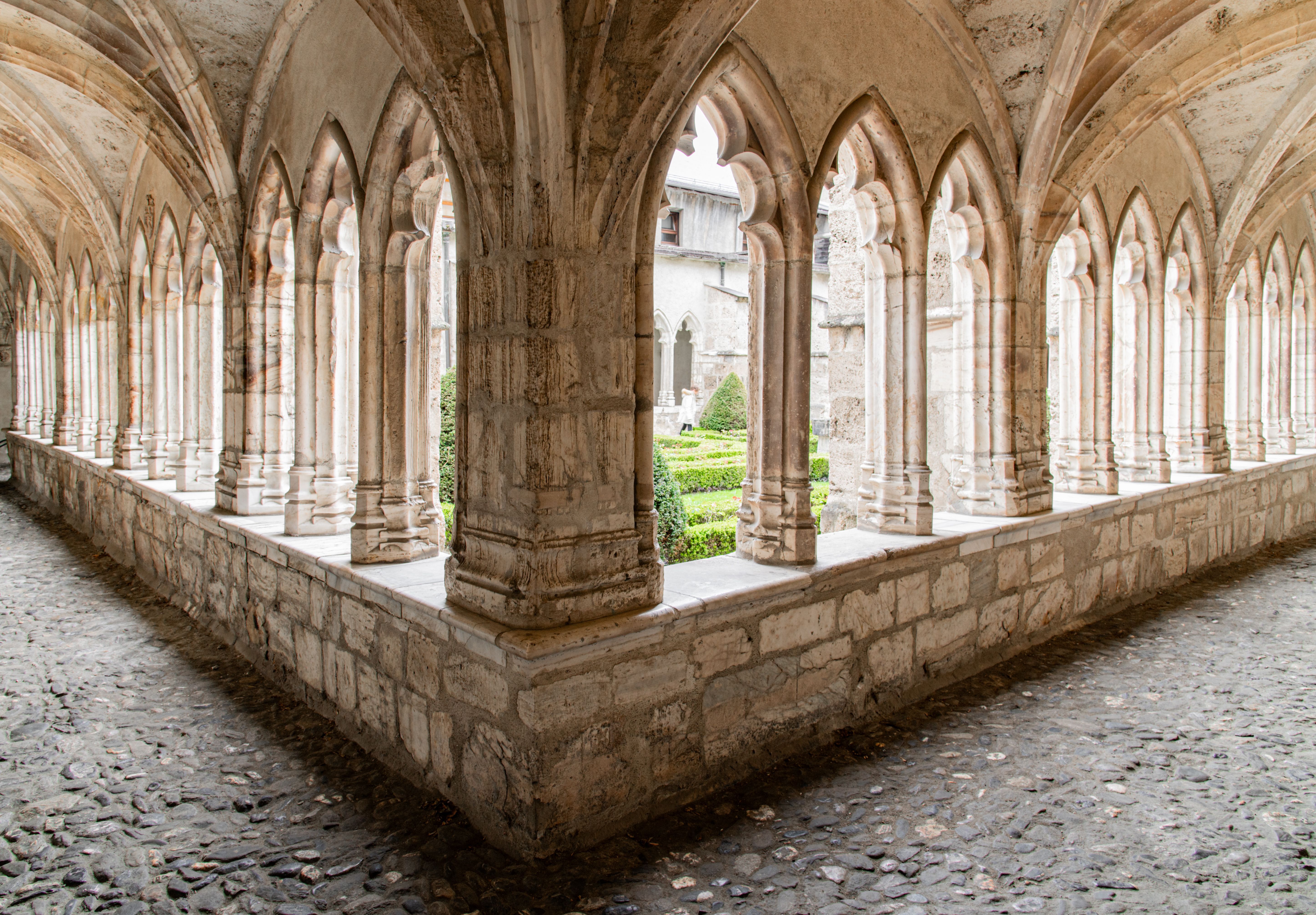 Quiet cloister garden with herb beds and Gothic arches beside Utrecht cathedral