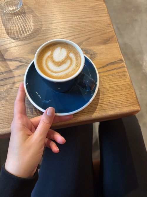 Free A serene coffee moment featuring elegant latte art in a cozy café setting. Stock Photo
