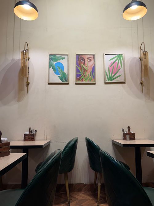 Free Elegant cafe setting with abstract art and ambient lighting, perfect for a relaxing atmosphere. Stock Photo