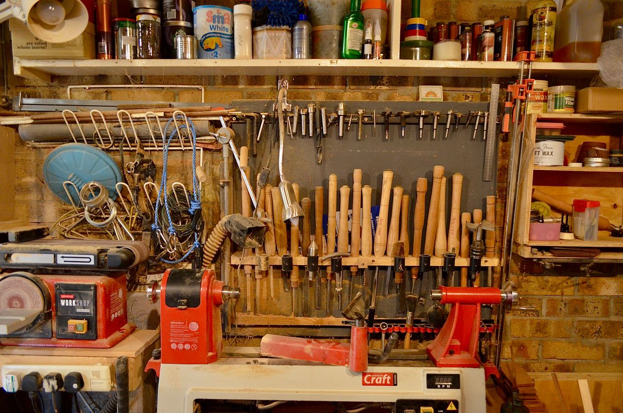 A fixed workbench with tools stored on the wall above it