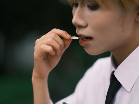 Artistic close-up of a cosplayer in Vietnam eating a petal, highlighting cosplay culture.
