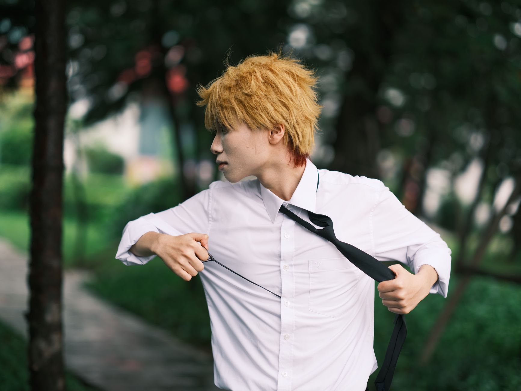 Dynamic cosplay portrait of an adult in a white shirt outdoors in Vietnam.