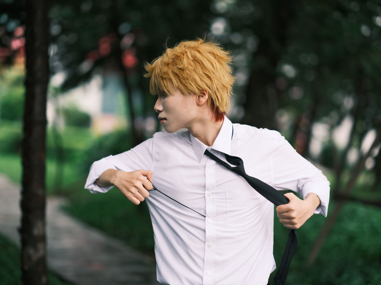 dynamic cosplay portrait of an adult in a white shirt outdoors in viet