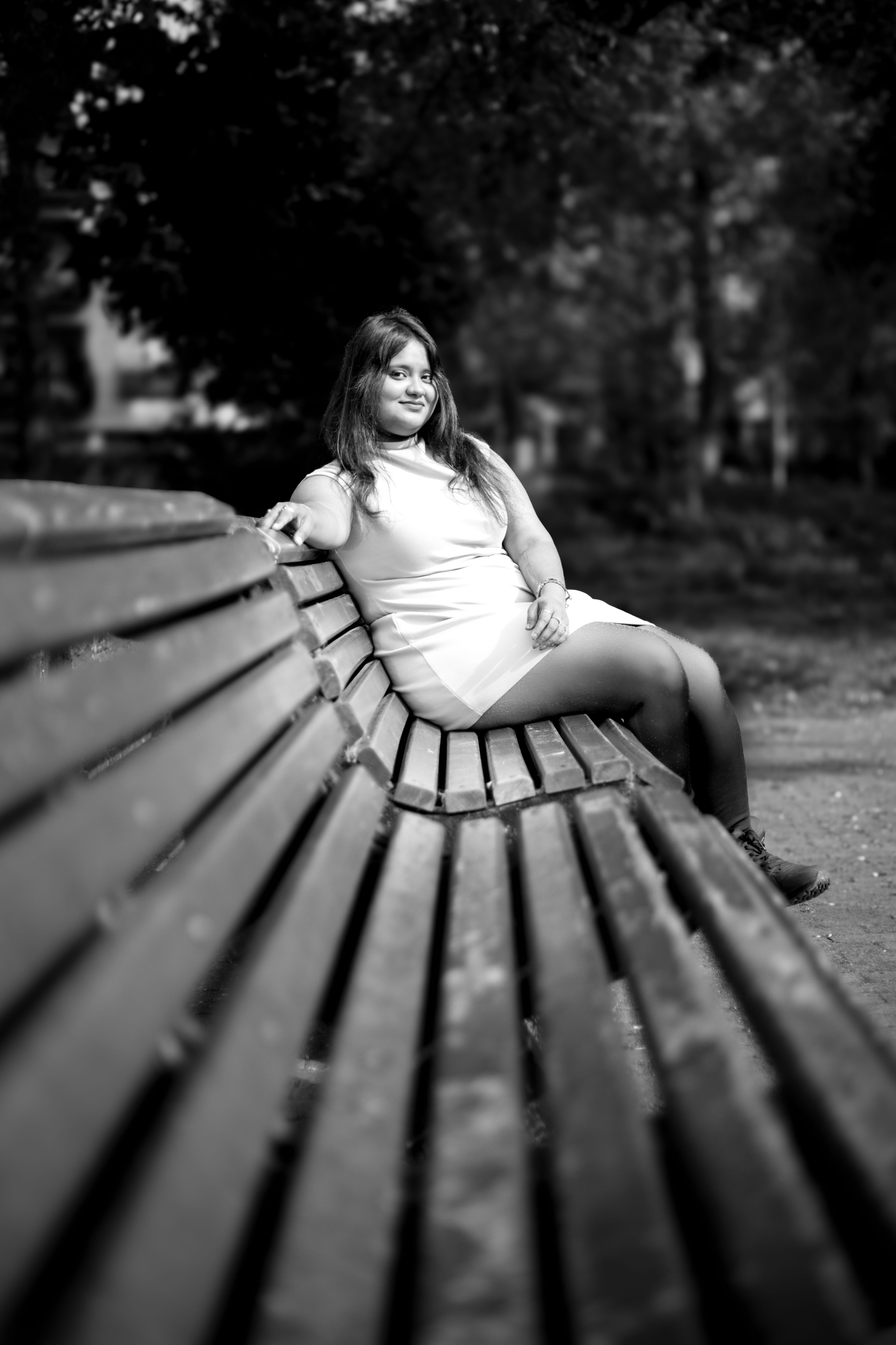 Relaxed Woman Sitting on Park Bench in Monochrome · Free Stock Photo