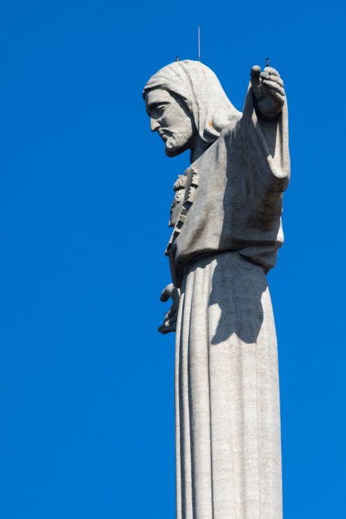 Free A close-up view of the Christ the Redeemer statue with a clear blue sky backdrop. Stock Photo