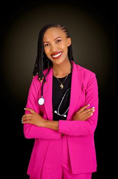 Confident female doctor in a pink blazer with a stethoscope, smiling against a black background.